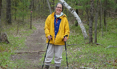 Marjorie Turner Hollman, '77, on a hike in the woods.