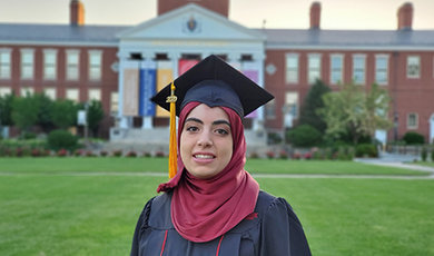 Hind Al Jurf in her cap and gown in front of Boyden Hall