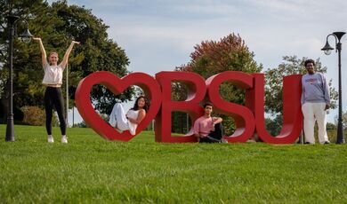 Four students pose by a red Heart BSU sculpture.