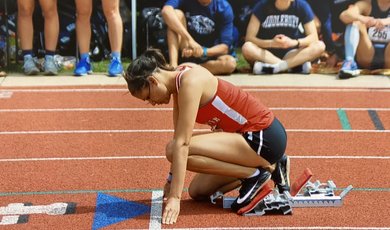 Jayci Andrews, '20, G'22 in the blocks before the start of a race