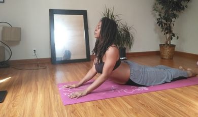 Johanne Barthold practices yoga in front of a mirror.