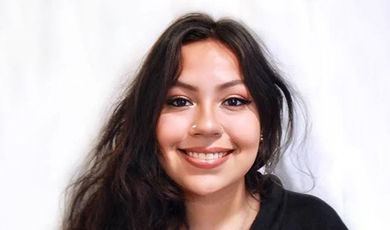 A headshot of Mitzy in front of a white background