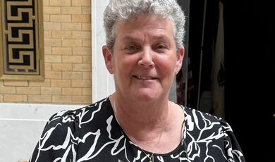 a woman with gray hair smiles