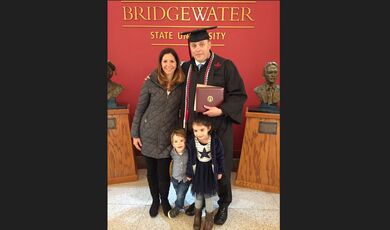 Weston Smith with his family in front of a BSU sign.