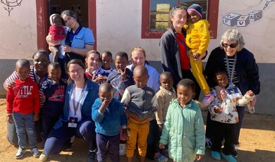 a group of small children with volunteers
