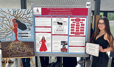 Sunnie Souza standing next to her research poster and painting
