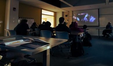 Students watch an episode of Star Wars in a classroom.