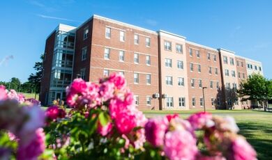 The exterior of Stonehouse Hall with flowers in the foreground.