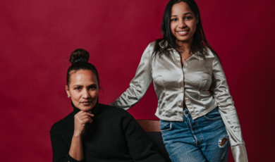 Cecilia sits in a chair with Hanice standing behind