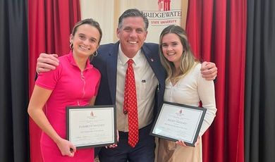 Kelsey and Elisabeth Sweeney receive sorority awards from President Clark.