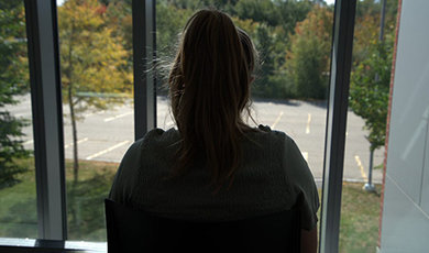 A student looks out a window.