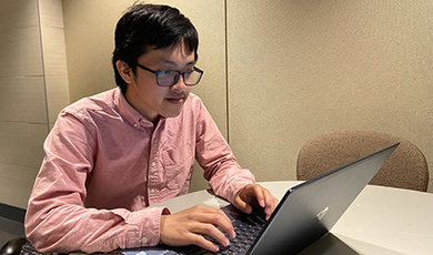 Lyhour Sreang works at a computer