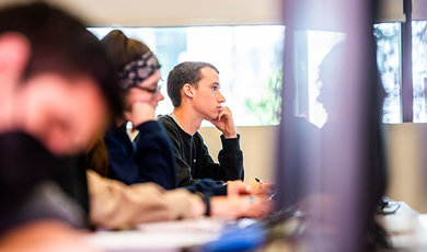 A criminal justice student listens intently in class