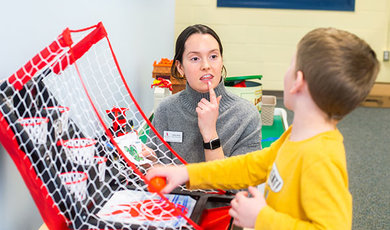 A speech-language pathology student works with a child