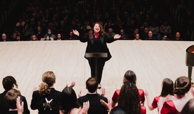 Colleen McDonough, '18, conducts high school choral students at Carnegie Hall