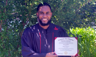 Emanuel De Pina, '20 holds up his degree