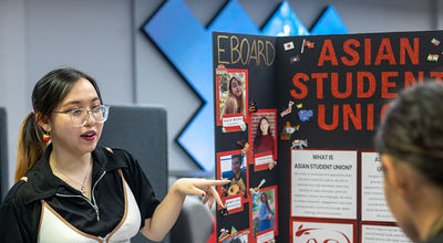 A member of the Asian Student Union talks about the group at the student involvement fair