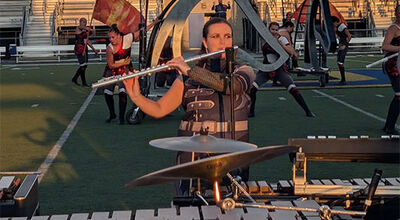 Delaney Hughes plays the flute in a football stadium.