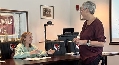 A student and instructor talk to each other.