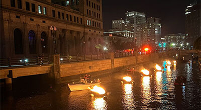 Bonfires set on a river light up downtown providence Providence.