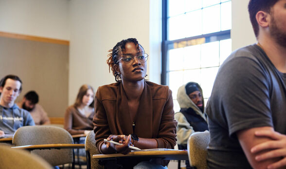 BSU female student of color paying attention in a management class