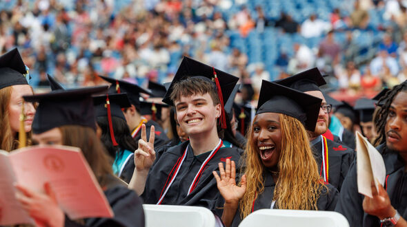 undergraduate commencement students wave