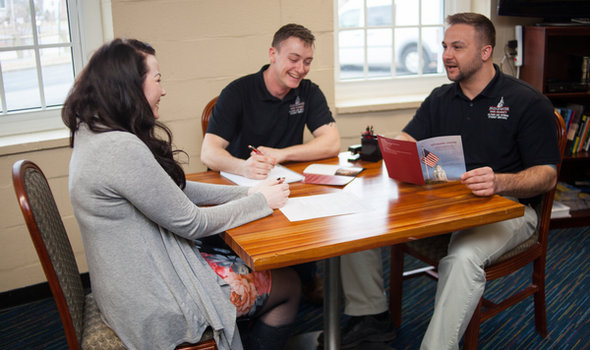 People in the BSU Veterans Center talking, smiling, looking at material