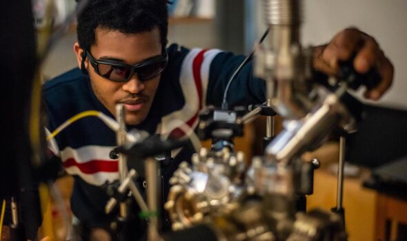 Student performs a photonics demonstration