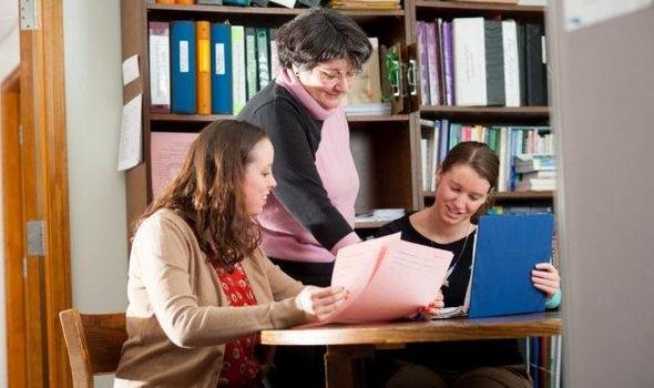 staff member assisting students
