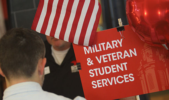 A close up of a red sign that says Military & Veteran Student Services