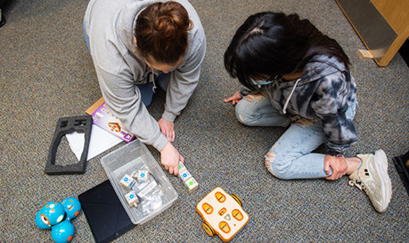 Two students working with programming toys