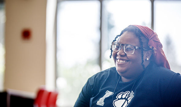 A student smiling in the sunlight at a LGCIE event