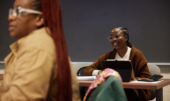 social work student sitting at her desk in class smiling