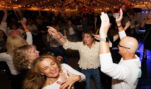 alumni dancing in the Alumni Homecoming Tent