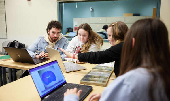 4 students working in the Psychology Lab looking