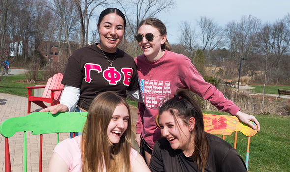 Four students laughing outside