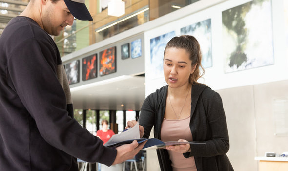 A BSU graduate admissions representative giving a student information