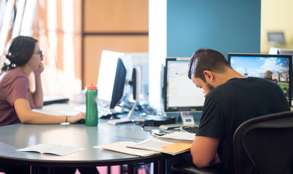 students at computers in the library