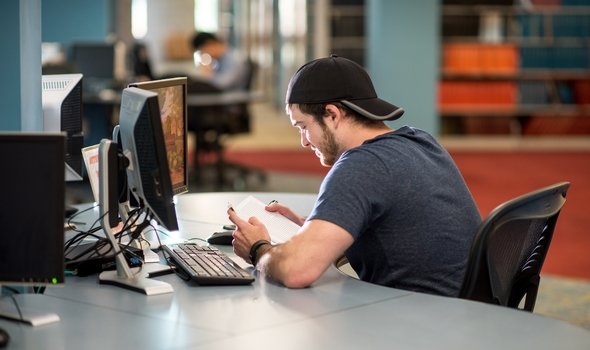 student at computer in Maxwell library