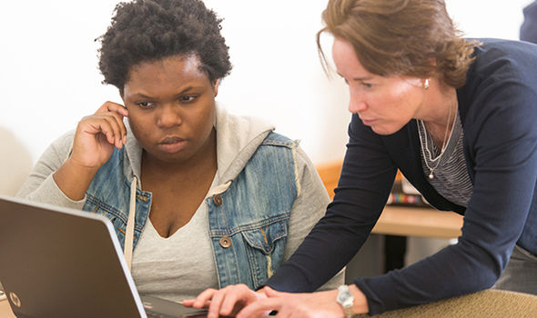 BSU professor MaryBeth Tobin talking with a student while they look at a computer