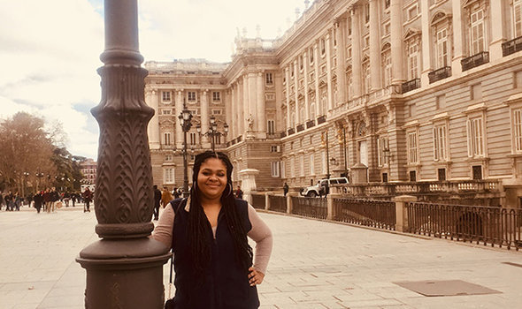 BSU student Brittany Christian standing in front of a large ornate building in Madrid, Spain, while on study abroad