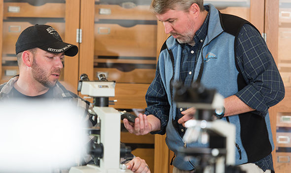 a BSU professor talking to a student in class
