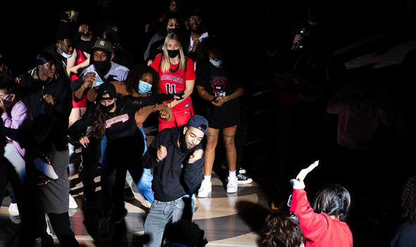 Students and student-athletes dancing and celebrating Midnight Madness