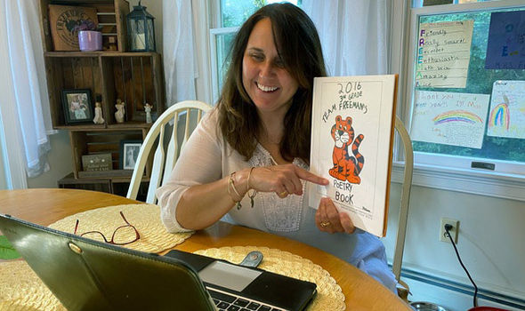 teacher Nichole Freeman teaching online from her home showing students a book