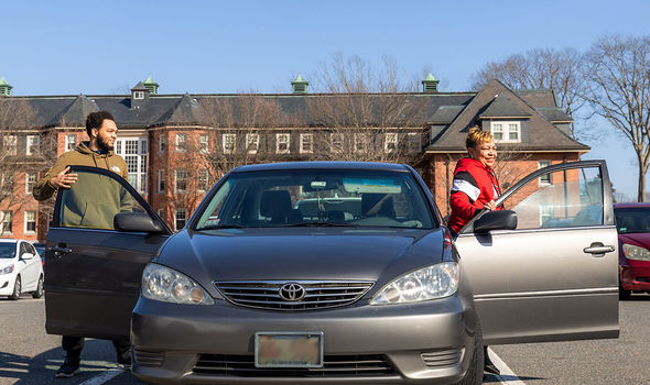 Two commuter students park exit their vehicle in the Harrington parking lot