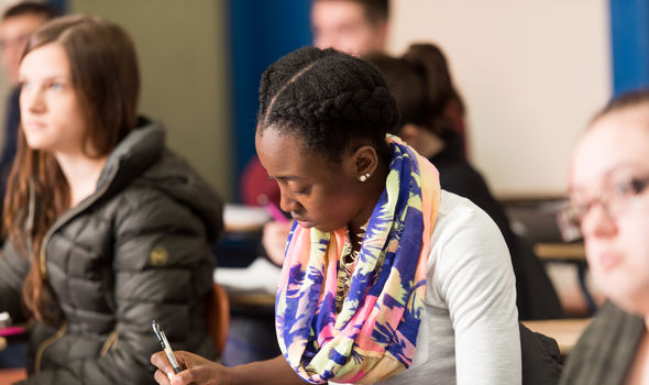 A student takes careful notes in philosophy class