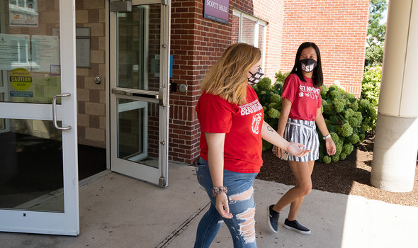 Two students walking out of Scott Hall