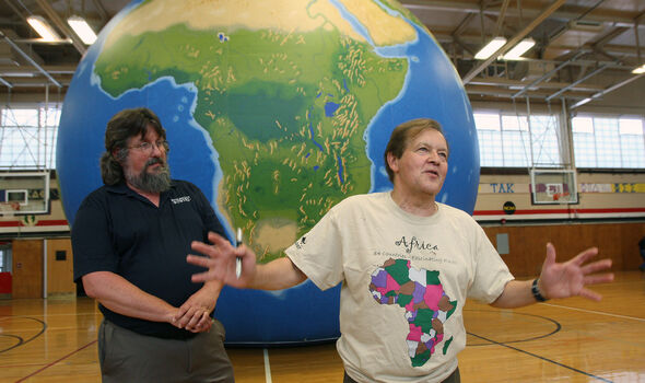 Dr. James Hayes-Bohanan and Dr. Vernon Domingo teaching with EarthView globe