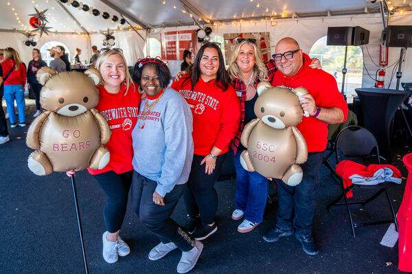 a group of BSU alumni in the Rathskellar Tent at Homecoming with specialized mylar bear balloons