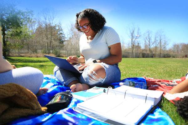 Student Studying on grass